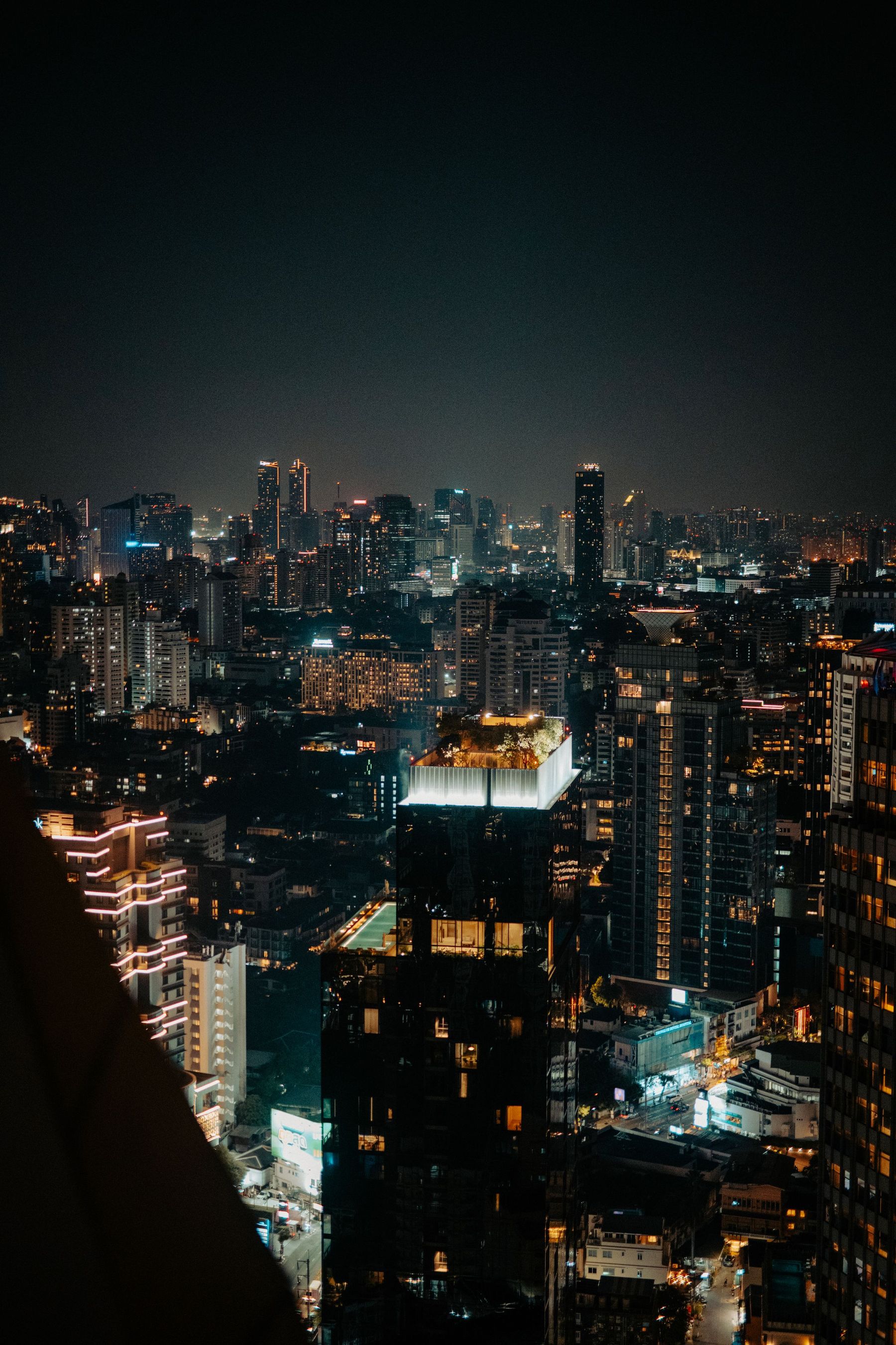 Bangkok's towers lit up at night above the busy streets