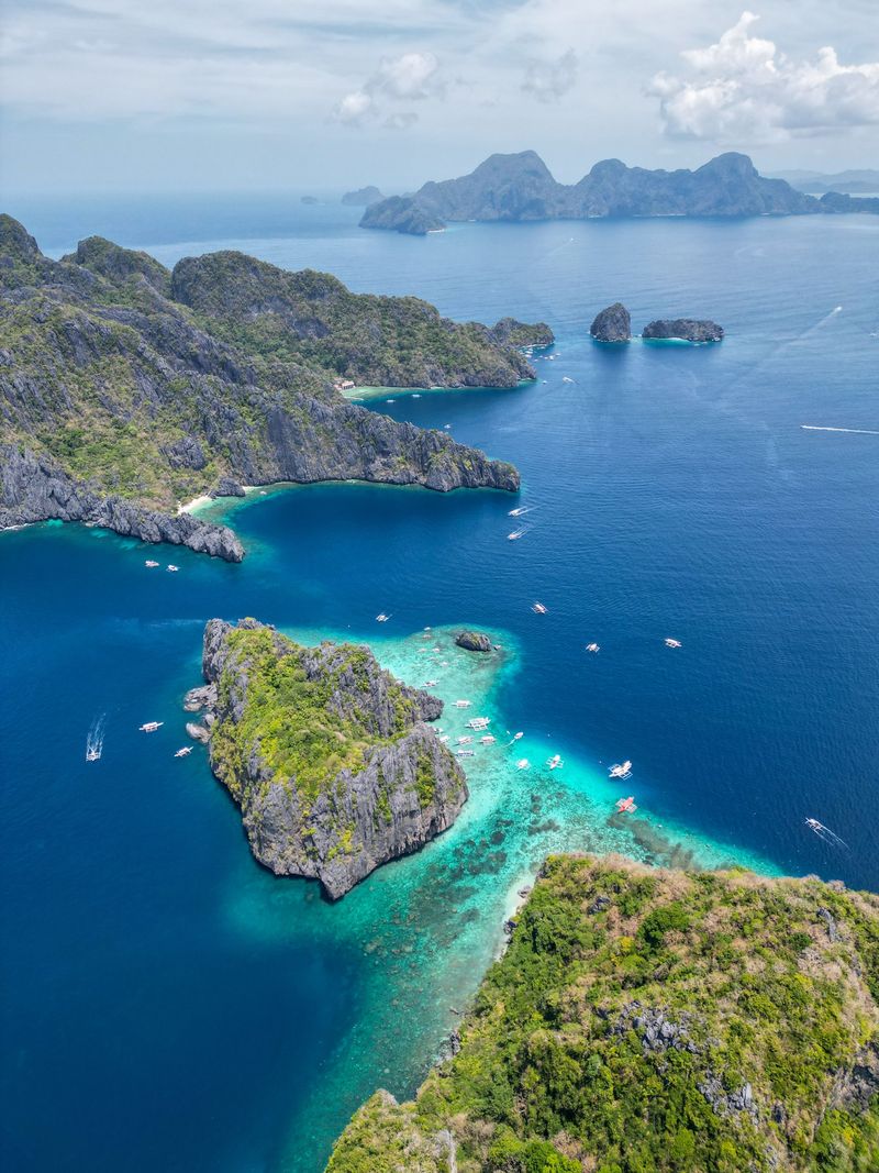 Green islands surrounded by deep blue sea, seen from a drone