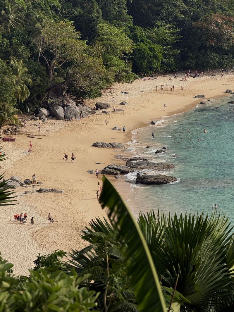 Golden sand and green hills on a beach in Phuket