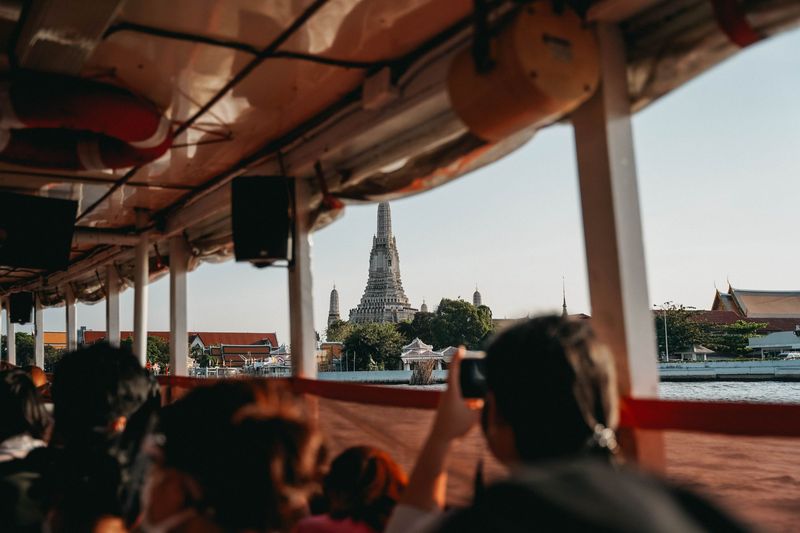 Wat Arun seen through the windows of a riverboat on the Chao Phraya