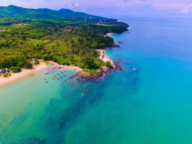 Aerial view of a beach and green hills on Koh Lanta