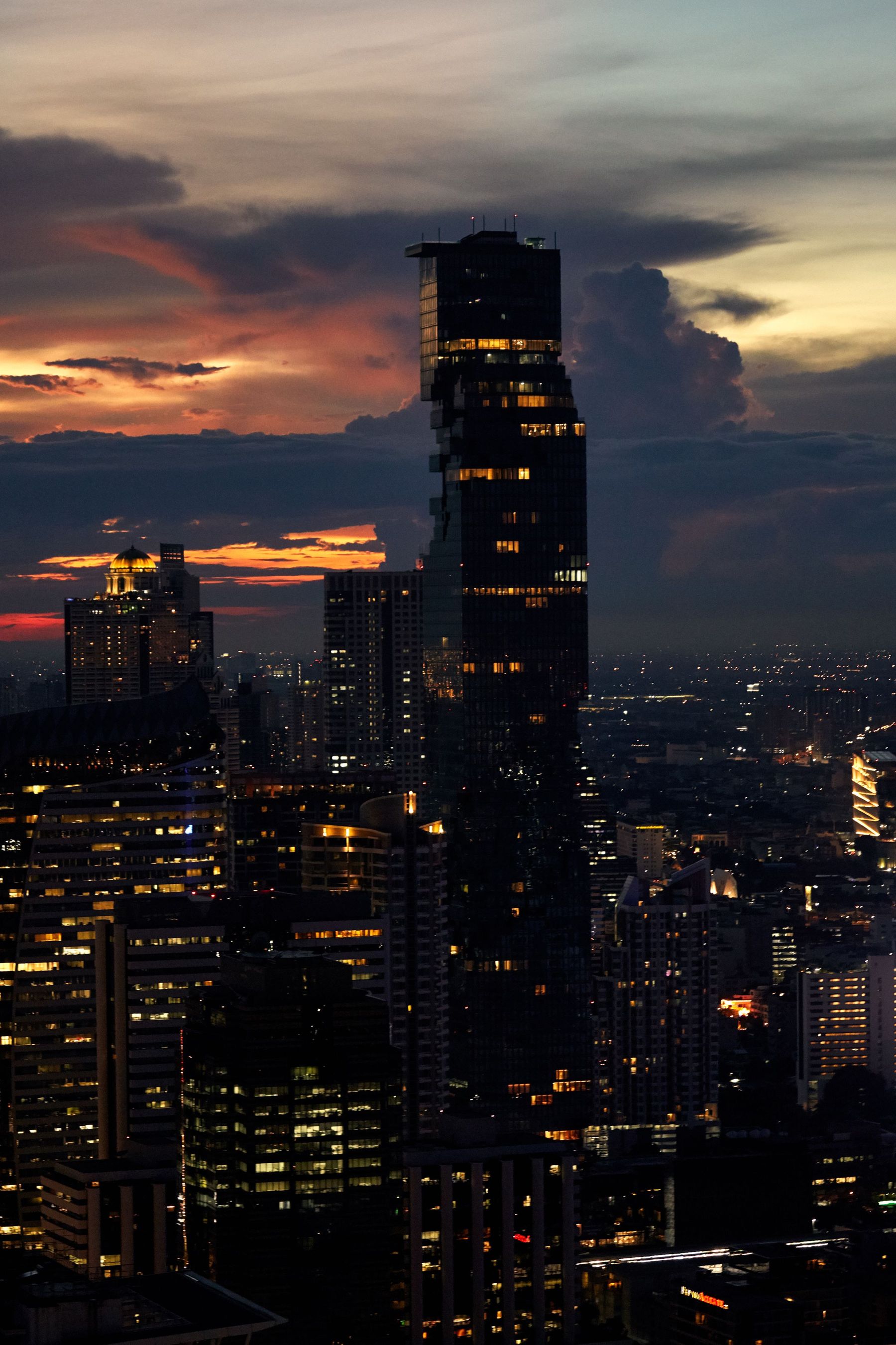 Bangkok's skyline at twilight, with the King Power Mahanakhon tower